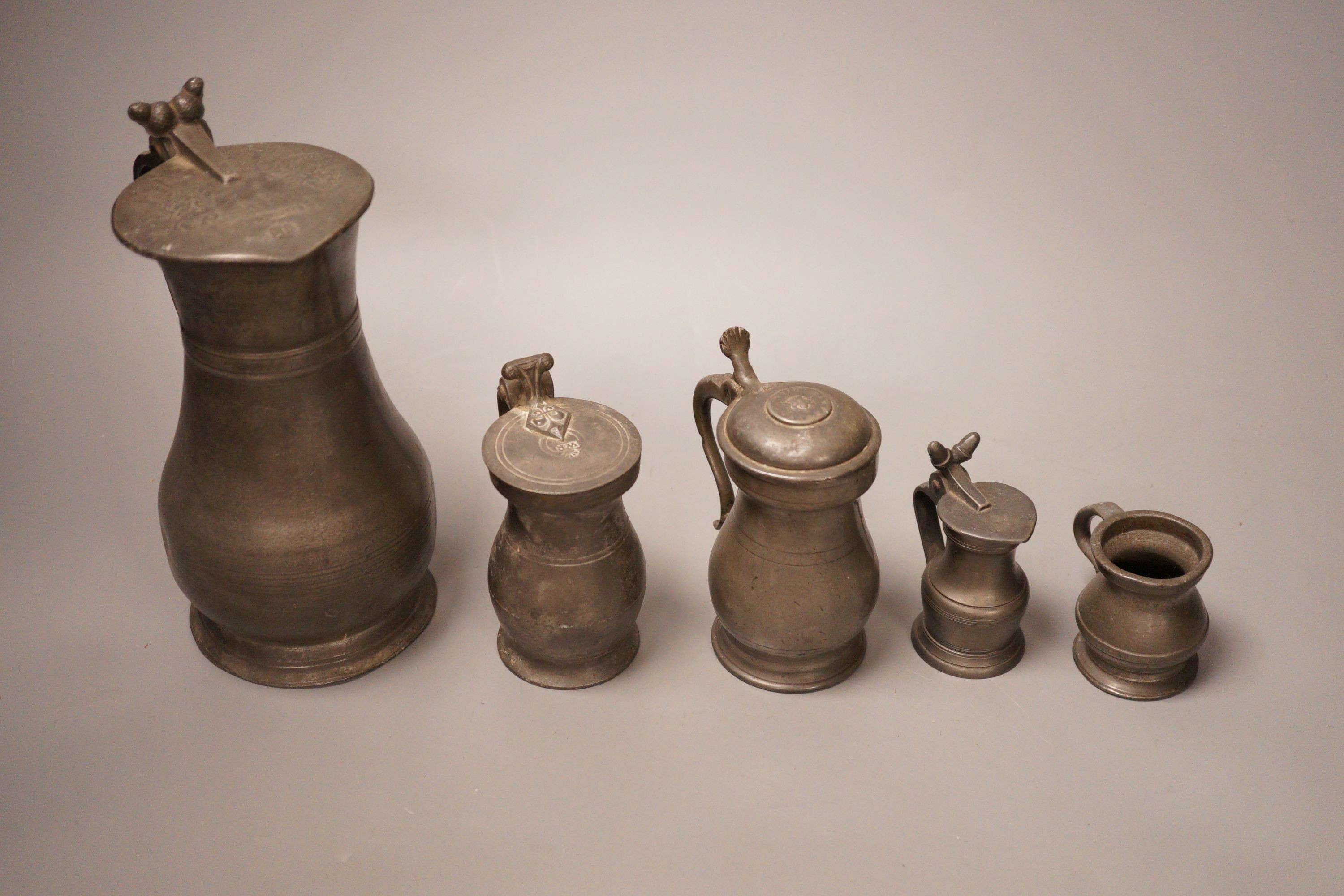 A group of 18th / 19th century pewter measures, 19cm